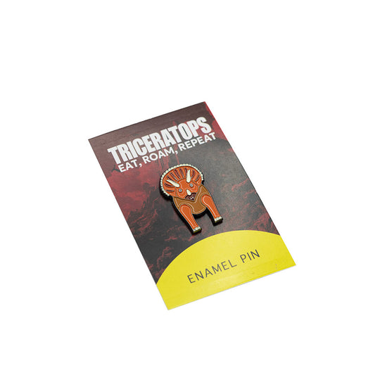 Enamel pin with Triceratops design on a card with text