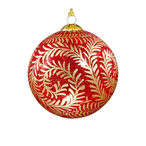  A round, red Christmas ornament decorated with gold-coloured vine patterns.