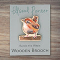 Wooden brooch with a wren motif. The brooch is on a grey backing card with Ellwood Parker branding.
