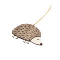 Hedgehog decoration in two tone brown and beige with a gold string attached to the back for hanging. Seen at an angle.