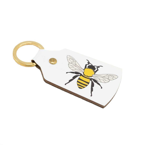 White recycled leather keyring with a yellow and black manchester bee print.