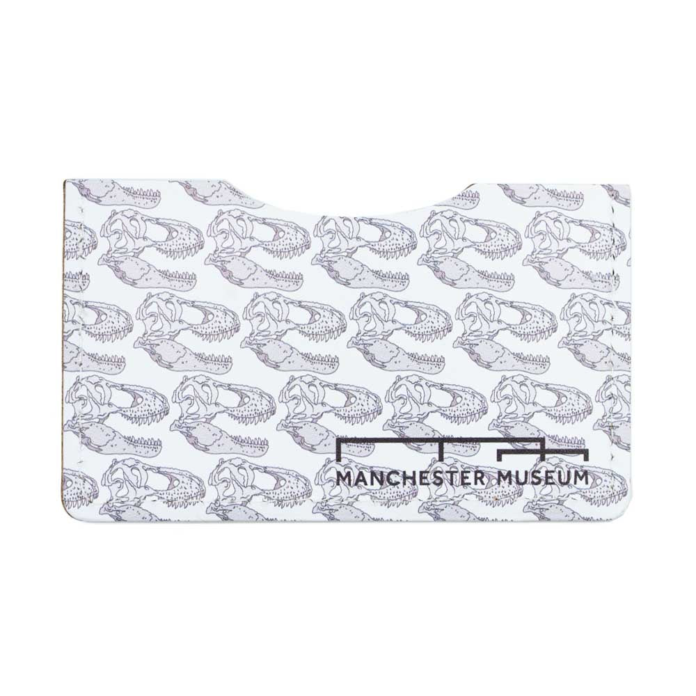 The all white and t-rex skull illustration front of the recycled leather card wallet. Musuem branding in the bottom right corner of the wallet.