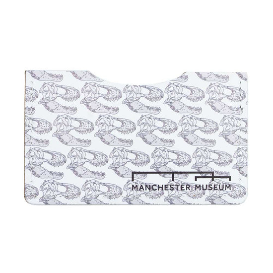The all white and t-rex skull illustration front of the recycled leather card wallet. Musuem branding in the bottom right corner of the wallet.