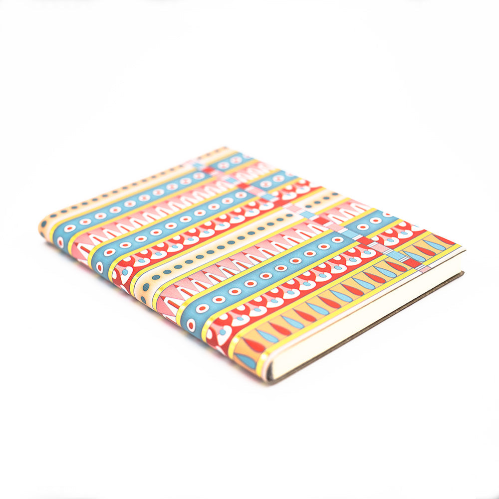 Load image into Gallery viewer, Side slightly angled view of the patterned notebook without the black belly band.
