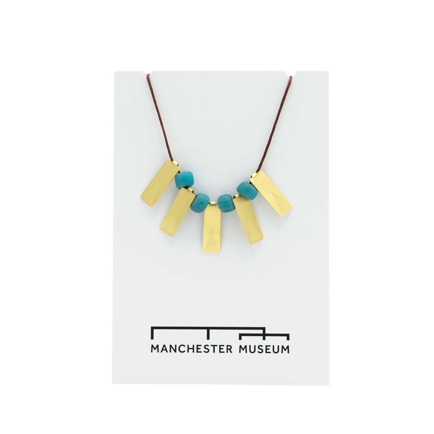 Load image into Gallery viewer, Five brass rectangular pendants with a turquoise glass bead between each. Brown string and presented on a white, museum branded backing card.
