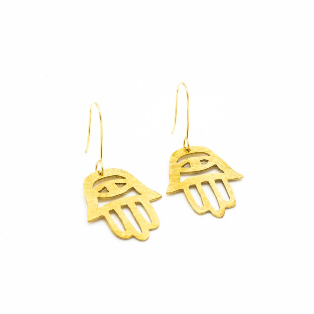 The brass earrings at a slight angle on a white background.