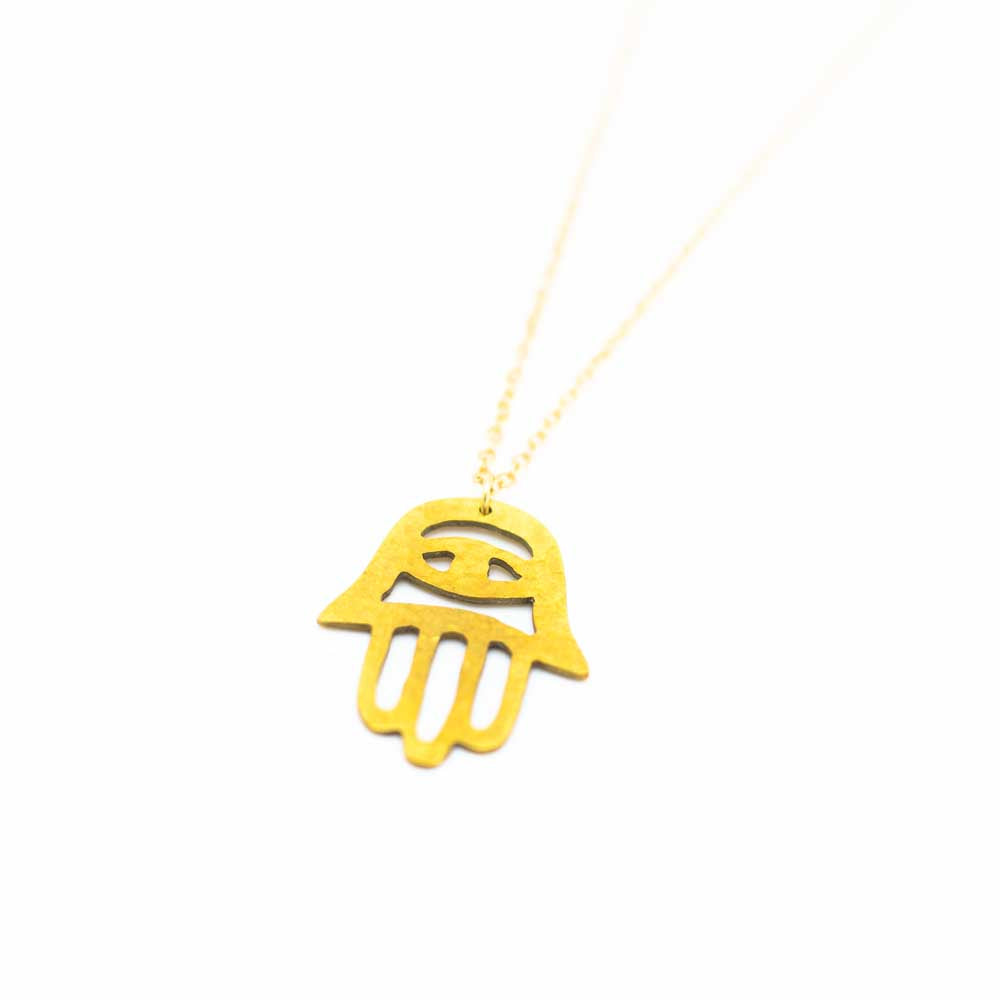 Fatima hand brass necklace with the chain vanishing off the image to the top right.