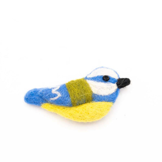 Felted blue tit brooch in yellow, blue and hite with a black beak.