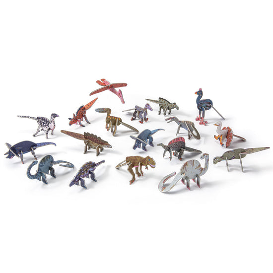 All the available dinosaur species assembled and set out on a white backdrop in a disarranged grouping.