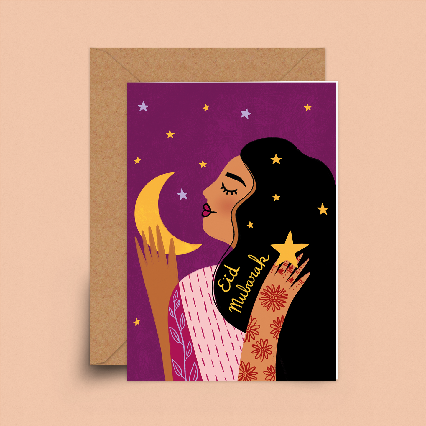 A purple card showing a praying person touching a crescent moon. In the black hair in yellow lettering the words are, eid mubarak.