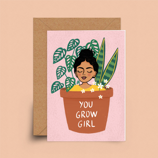 Pale pink card with a large flower pot with two plants and the bust of a smiling person growing out from the top.