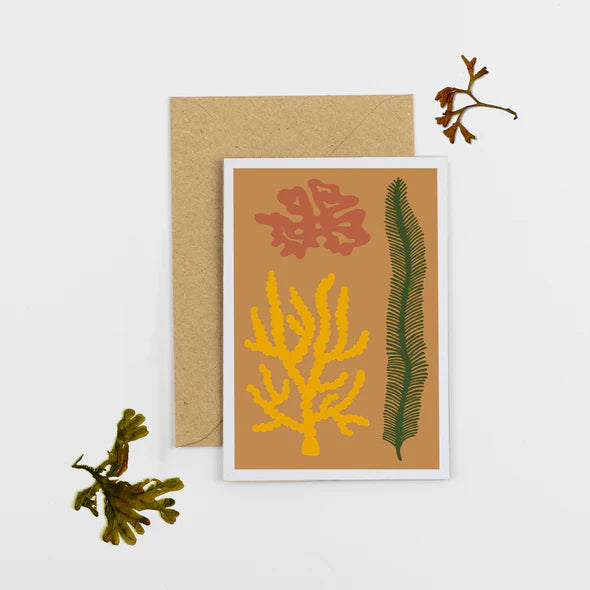 Mustard greetings card and brown envelope. The card has different coloured seaweed abstract design.