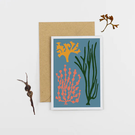 Blue greetings card and brown envelope. The card has different coloured seaweed abstract design.