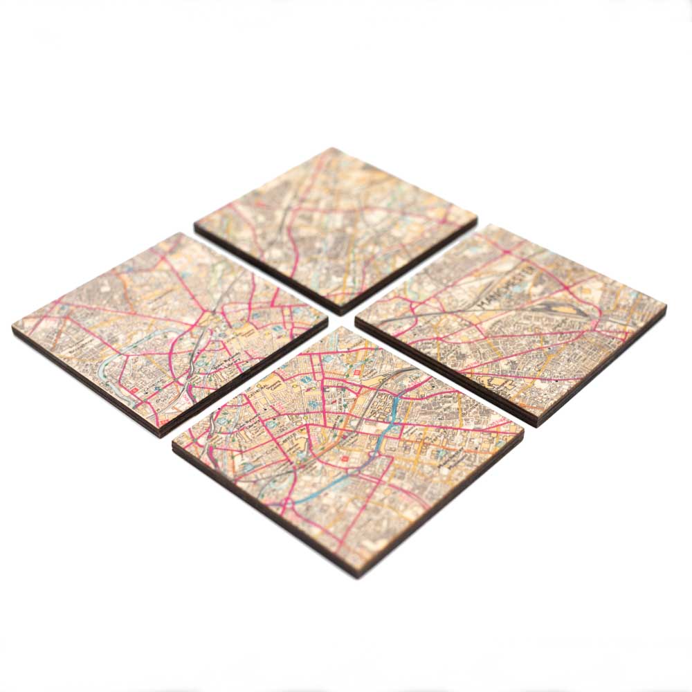 Load image into Gallery viewer, Four coasters with Manchester map design.
