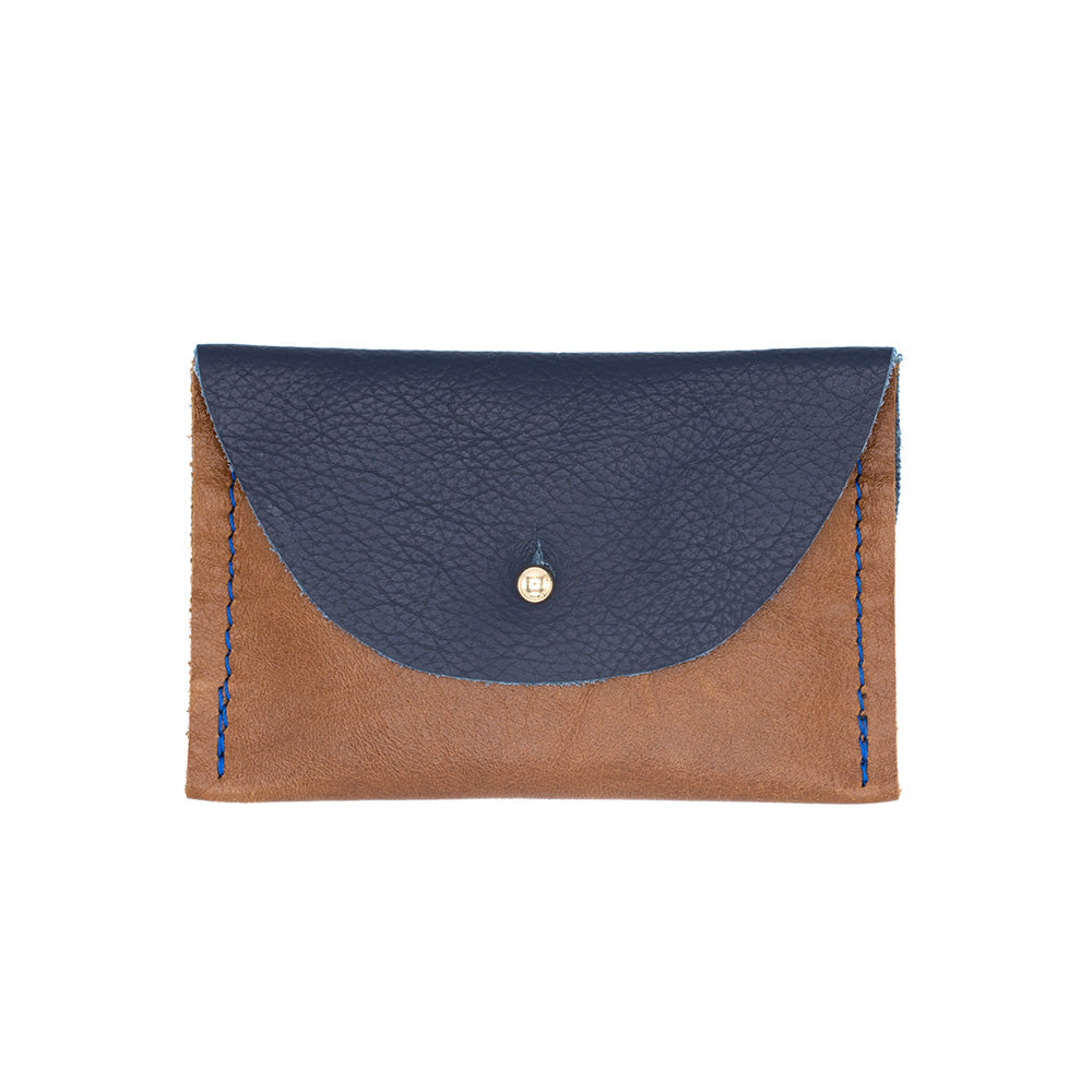 Navy and tan purse with a golden rivet closure.