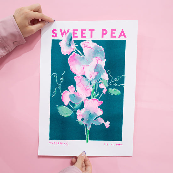 A risograph print featuring an illustration of a sweet pea flower. Pink background.