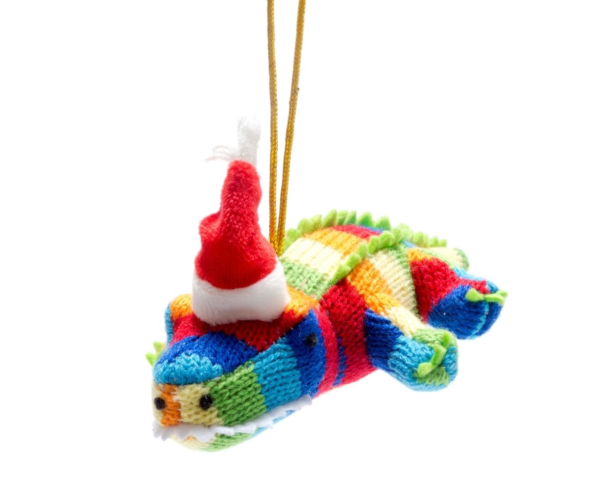 Rainbow crocodile with a santa hat with a golden looped thread for hanging.
