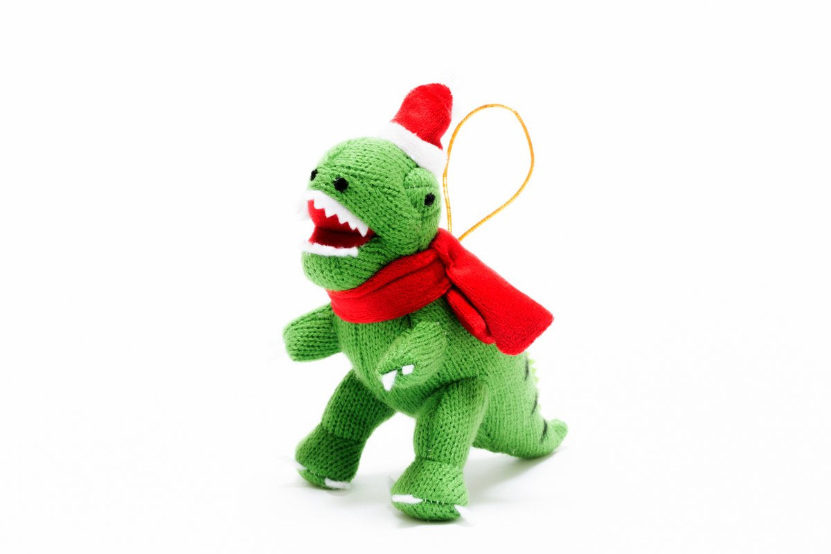 Green t-rex with a scarf and santa hat with a golden looped thread for hanging.