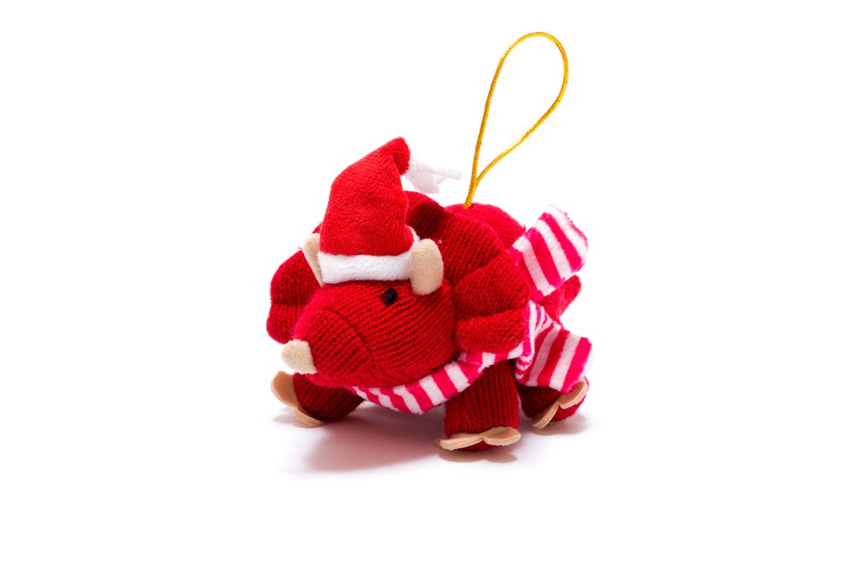 Red triceratops with a scarf and santa hat with a golden looped thread for hanging.