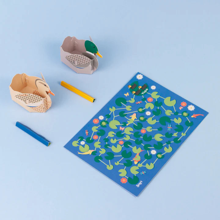 Lifestyle shot of the assembled ducks with the game board laid out.