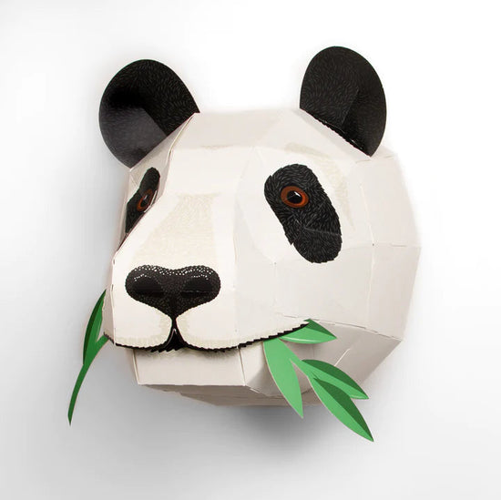 The panda head after assembly hung on a white wall.