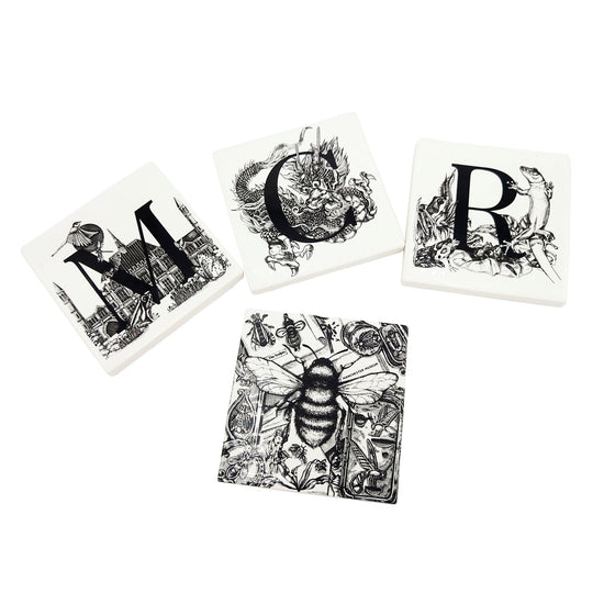 All four coasters available in the coaster setlaid out with M, C and R on top and the bee coaster below.