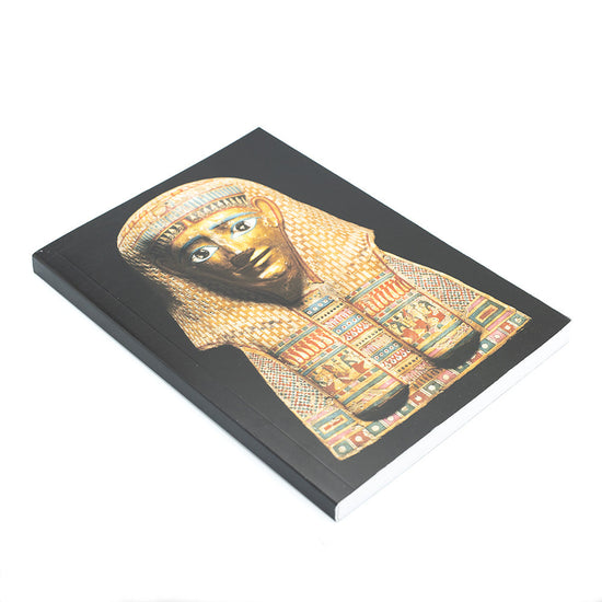 Slightly angled view of black notebook with photograph of burial mask.