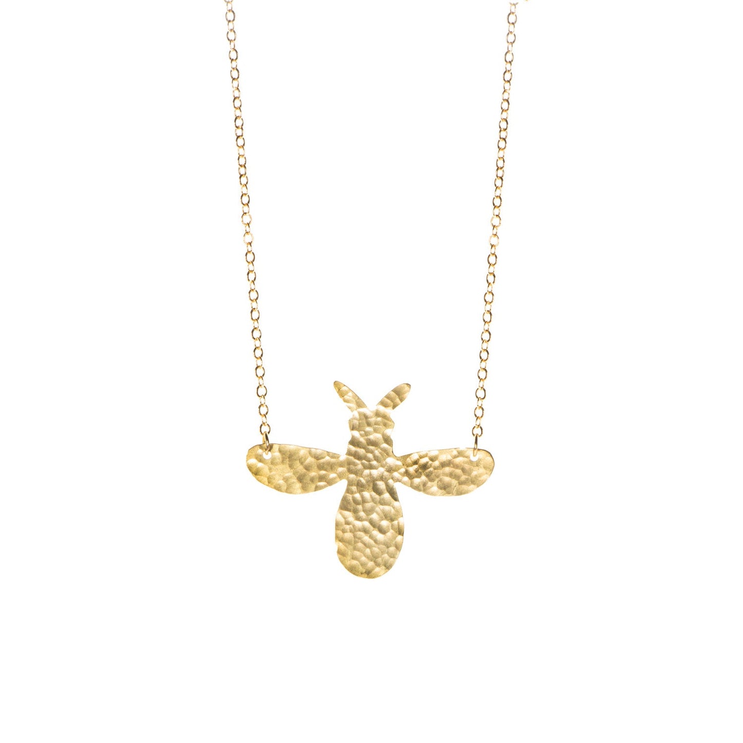 Brass bee pendant on a white background.