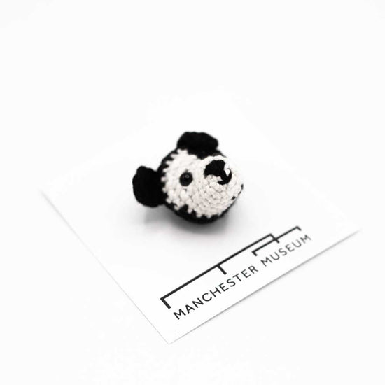 Hand crocheted Murray the therapy dog brooch. head of black and white dog.