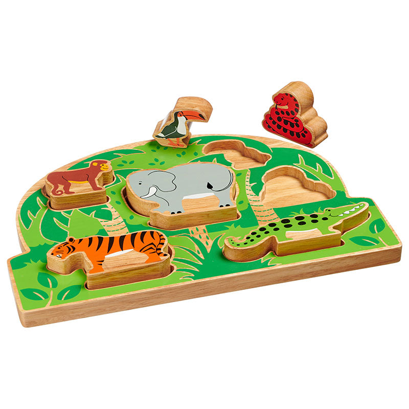 The shape sorter placed on a white surface with the toucan and snake lifted out to sit on top of and beside the sorter.