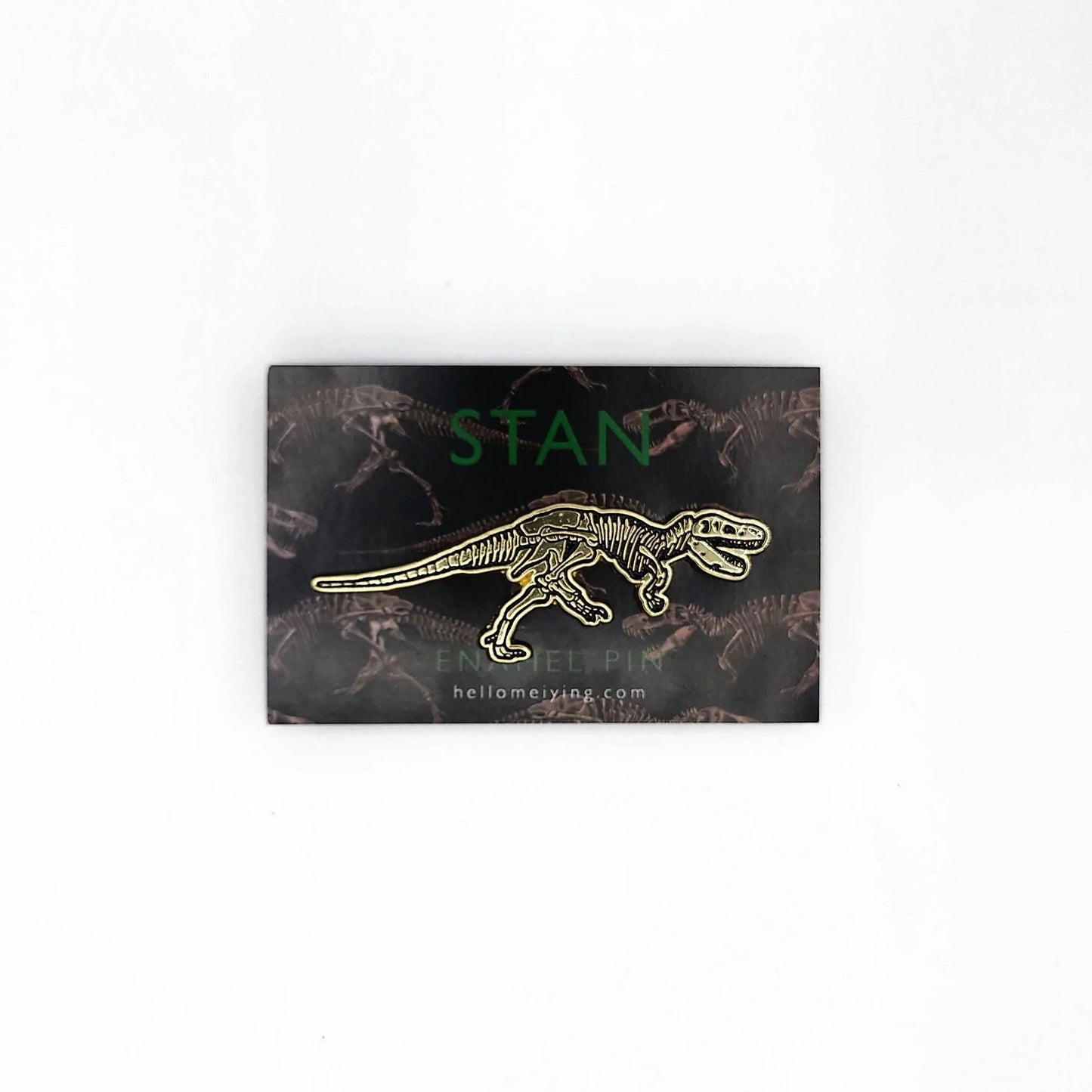 Load image into Gallery viewer, The golden Stan pin on the dark backing card which has the Stan illustration in a repeat pattern. Above the pin in dark green sans serif font it says, Stan.
