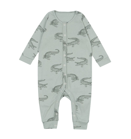 The sage green baby romper with long sleeves and crocodile outline print against a white background.