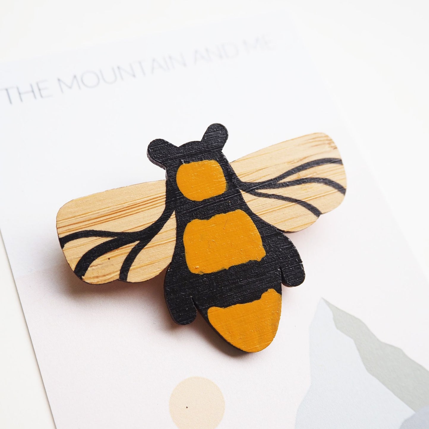 Manchester bee bamboo brooch. Close up of the brooch on the Mountain and me branded backing card.