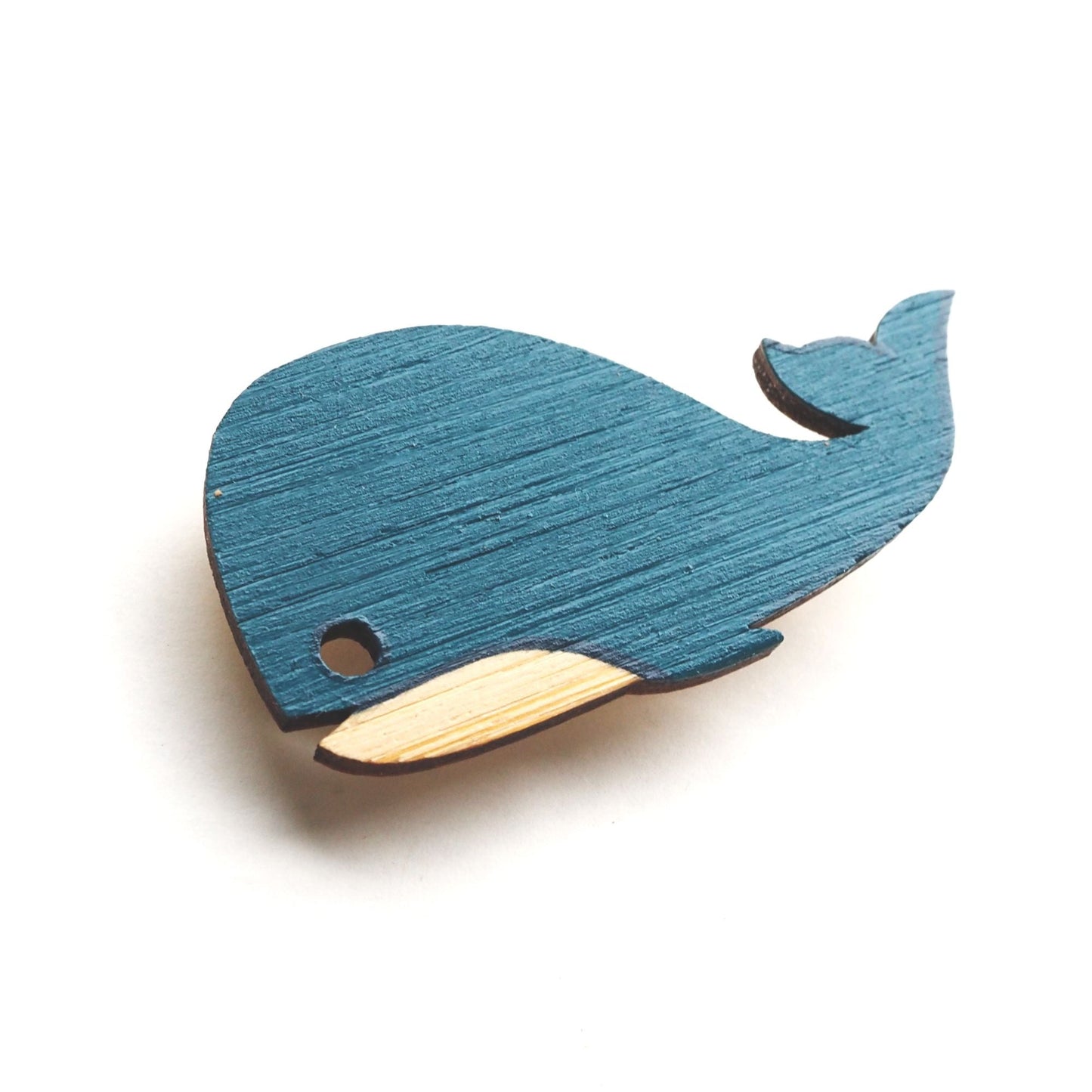 Whale brooch on a white background.