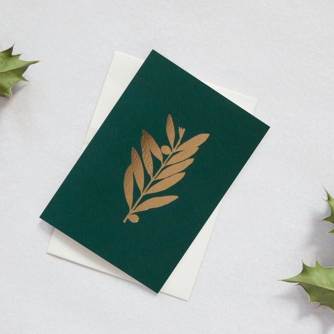 Load image into Gallery viewer, Dark green card with a brass foil olive branch motif.
