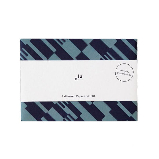 Anni print patterned paper kit with a white belly band around it. The pattern is dark and pale blue.