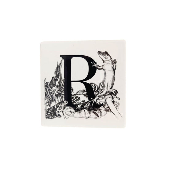 R coaster with a simplified version of the bespoke museum R tile. Frogs and a gecko are around the letter.