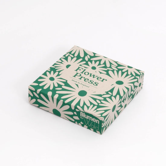 Box packaging for the flower press. Green and cream abstract daisy pattern.