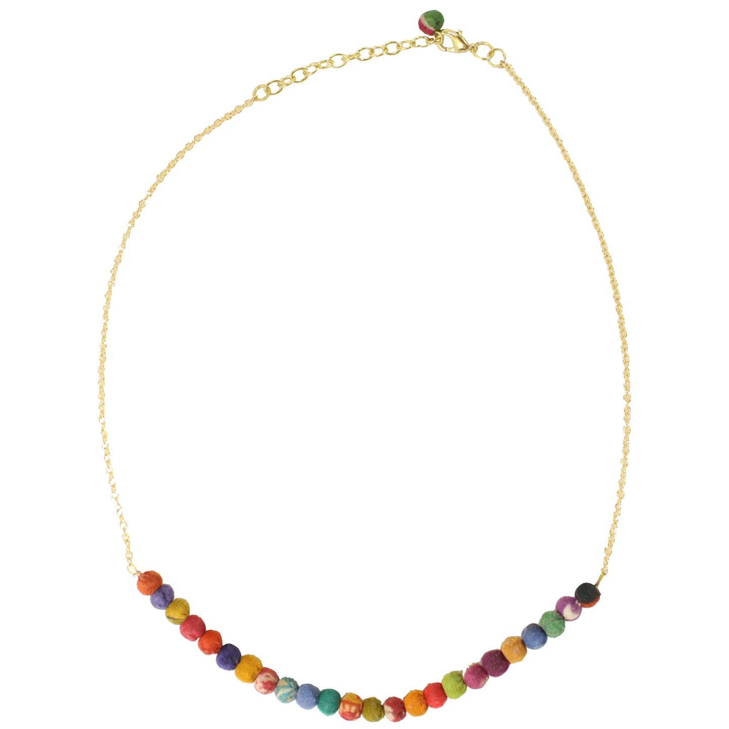 The golden necklace with small kantha beads at the bottom agaisnt a white background.